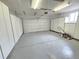 A spacious two car garage with built in white storage cabinets and grey epoxy flooring at 426 Jupiter Dr, Lone Tree, CO 80124