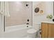 Modern bathroom showcasing a tub, shower, and stylish vanity with neutral tile at 1344 N Knox Ct, Denver, CO 80204