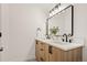 Stylish bathroom featuring double sinks, modern vanity with wood grain cabinets, and sleek black hardware at 1344 N Knox Ct, Denver, CO 80204