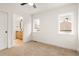 Clean bedroom featuring carpet floors, white trim, large windows, and ensuite bathroom at 1344 N Knox Ct, Denver, CO 80204