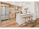 Bright kitchen with bar seating, modern appliances, and wood cabinetry at 1344 N Knox Ct, Denver, CO 80204