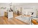 Open-concept living space with wood floors, stylish decor, and a modern staircase at 1344 N Knox Ct, Denver, CO 80204