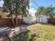 Large backyard with shed, patio, and mature trees at 2537 Chase St, Edgewater, CO 80214