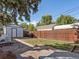 Landscaped backyard with patio, shed, and wooden fence at 2537 Chase St, Edgewater, CO 80214