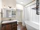 Updated bathroom features a soaking tub, shower, and wood vanity at 2537 Chase St, Edgewater, CO 80214