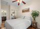 Bright bedroom with mirrored closet doors and ceiling fan at 2537 Chase St, Edgewater, CO 80214