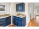 Small galley style kitchen with blue cabinets and granite countertops at 2537 Chase St, Edgewater, CO 80214