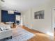 Spacious living room with hardwood floors, and a view into the kitchen at 2537 Chase St, Edgewater, CO 80214