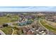 Community aerial view featuring tennis courts, clubhouse, and well-maintained landscaping at 7895 S Zante Ct, Aurora, CO 80016