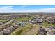 Beautiful aerial view of the community showcasing a golf course, tennis courts and lush greenery at 7895 S Zante Ct, Aurora, CO 80016