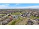 An aerial view shows this home's prime location near a golf course, clubhouse, and tennis courts at 7895 S Zante Ct, Aurora, CO 80016