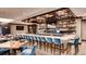 Upscale bar with a coffered ceiling and television, with a long counter and multiple chairs at 7895 S Zante Ct, Aurora, CO 80016