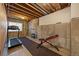 Unfinished basement with exposed beams, a treadmill and exercise equipment at 7895 S Zante Ct, Aurora, CO 80016