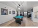 Finished basement showcasing a pool table, wet bar, and comfortable seating area for entertainment at 7895 S Zante Ct, Aurora, CO 80016