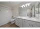 Bright bathroom featuring a shower-tub combination and a large vanity with ample storage at 7895 S Zante Ct, Aurora, CO 80016