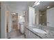 Bathroom with dual sinks, granite countertops, tile floor, and walk-in shower at 7895 S Zante Ct, Aurora, CO 80016