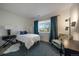 This cozy bedroom features a plush rug, a desk, a chair and a comfortable bed at 7895 S Zante Ct, Aurora, CO 80016