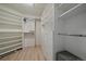 Walk in closet with custom shelving, drawers, and hardwood floors at 7895 S Zante Ct, Aurora, CO 80016