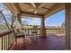 Inviting covered patio featuring wood flooring, ceiling fan, and views of the community golf course at 7895 S Zante Ct, Aurora, CO 80016
