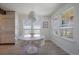 Bright dining area with modern light fixture, large windows, and hardwood floors at 7895 S Zante Ct, Aurora, CO 80016