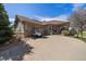 Charming home featuring a well-manicured lawn, a golf cart and a welcoming front porch at 7895 S Zante Ct, Aurora, CO 80016