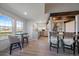 Bright and airy eat-in kitchen with wood beam accents with bar-top seating overlooking the large windows at 7895 S Zante Ct, Aurora, CO 80016