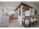 Bright eat-in kitchen features white cabinetry, stainless steel appliances, and decorative wood beam at 7895 S Zante Ct, Aurora, CO 80016