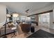 Inviting living room boasts contemporary design, a stylish fireplace, and a seamless flow into the dining area at 7895 S Zante Ct, Aurora, CO 80016