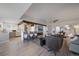 This open-concept living room features an eat-in kitchen, modern fireplace, and contemporary decor at 7895 S Zante Ct, Aurora, CO 80016