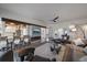 Spacious living room showcases a modern fireplace, sleek furniture, and seamless access to an adjacent dining area at 7895 S Zante Ct, Aurora, CO 80016