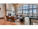 Welcoming lobby with stone fireplace, large windows, herringbone wood floors and comfortable seating at 7895 S Zante Ct, Aurora, CO 80016