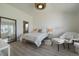 Bright bedroom with accent lighting, large window, and hardwood floors at 7895 S Zante Ct, Aurora, CO 80016