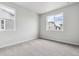 Bright and airy bedroom with neutral carpeting and large windows offering natural light at 14101 Deertrack Ln, Parker, CO 80134