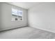 Clean, bright bedroom featuring neutral carpeting, fresh paint, and a large window at 14101 Deertrack Ln, Parker, CO 80134