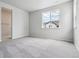 Bright bedroom with plush carpeting and a large window for natural light at 14101 Deertrack Ln, Parker, CO 80134