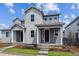 Charming gray home with well-manicured lawn, covered entry, and tidy landscaping under a bright blue sky at 14101 Deertrack Ln, Parker, CO 80134