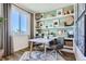 Bright home office space featuring a large window, minimalist desk, and decorative shelving at 14101 Deertrack Ln, Parker, CO 80134