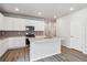 Modern kitchen featuring white cabinets, stainless steel appliances, and a central island with a sink at 14101 Deertrack Ln, Parker, CO 80134