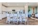 White kitchen featuring an island with barstool seating, stainless appliances, and ample cabinet space at 14101 Deertrack Ln, Parker, CO 80134