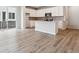 Bright, open-concept kitchen featuring white cabinetry, stainless steel appliances, and an island at 14101 Deertrack Ln, Parker, CO 80134