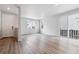Bright and airy living room with wood-look flooring, large windows, and sliding door access at 14101 Deertrack Ln, Parker, CO 80134