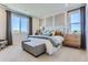 Bright main bedroom features neutral decor, large windows, and an upholstered bench at 14101 Deertrack Ln, Parker, CO 80134