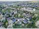 An overhead view of a housing community with mature trees and sidewalks on an overcast day at 20838 Parliament Ct, Parker, CO 80138