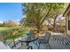 Relaxing back patio area with outdoor seating, a beautiful tree and view to open green space at 20838 Parliament Ct, Parker, CO 80138