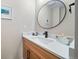 Modern half bathroom featuring a stylish mirror, vanity, countertop, and a unique sink fixture at 20838 Parliament Ct, Parker, CO 80138