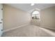 Bedroom featuring neutral paint, carpet and uniquely arched window at 20838 Parliament Ct, Parker, CO 80138