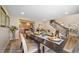 Inviting dining area with access to the kitchen and stairway, featuring hardwood floors and a modern aesthetic at 20838 Parliament Ct, Parker, CO 80138