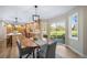 Dining area with an open kitchen, a wood table, and sliding glass doors leading to an outdoor space at 20838 Parliament Ct, Parker, CO 80138