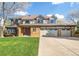 Two-story home showcasing a three-car garage, well-maintained lawn, and traditional architectural design at 20838 Parliament Ct, Parker, CO 80138