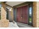 Front entrance featuring a double door, brick columns, and a covered porch at 20838 Parliament Ct, Parker, CO 80138